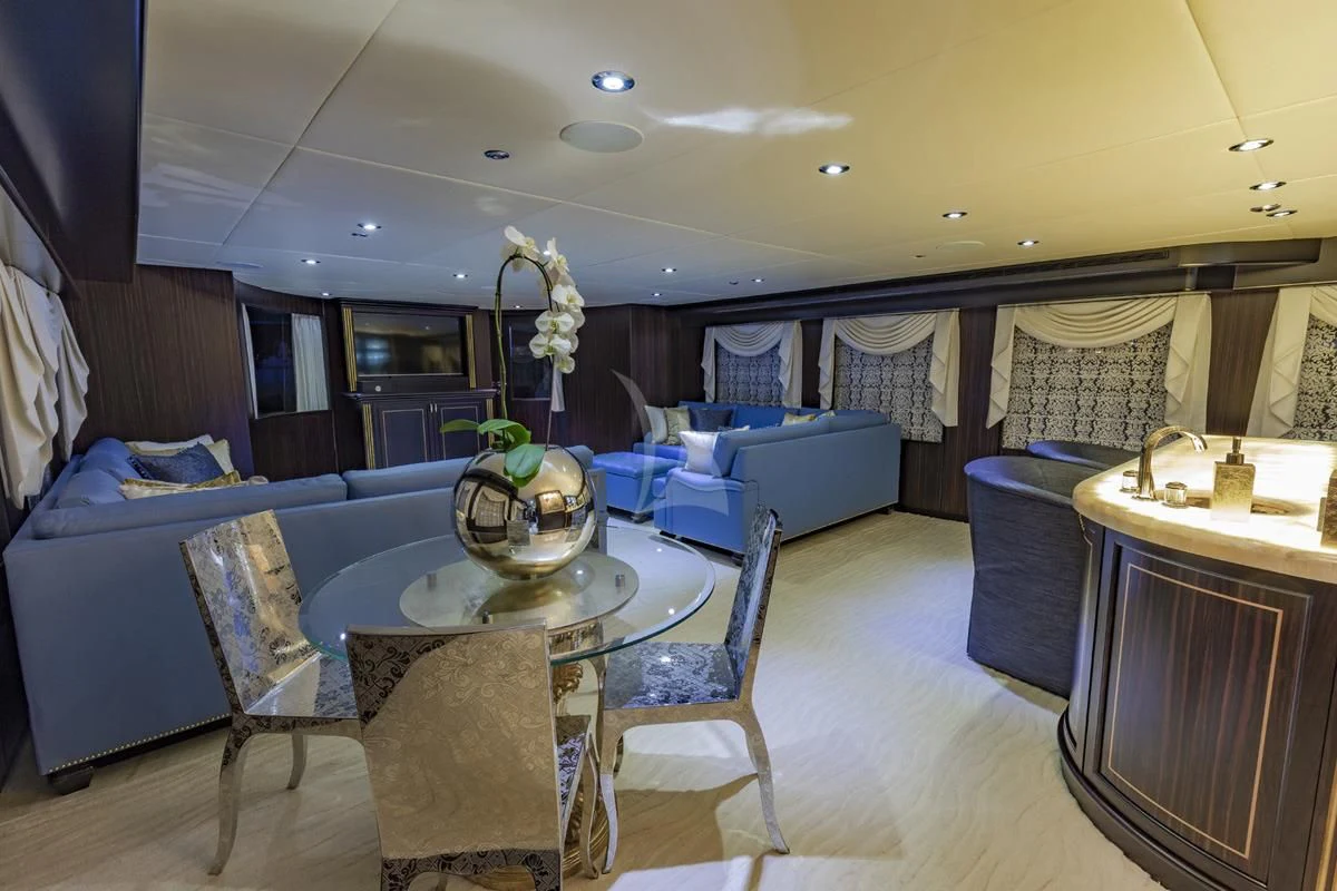 a living room with a large table and chairs aboard GRADE I Yacht for Charter