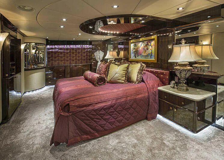 a bedroom with a large bed aboard GRADE I Yacht for Charter