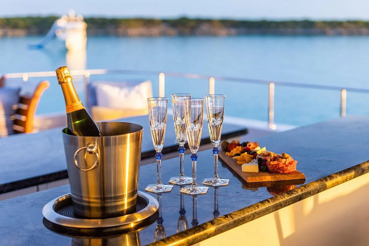a table with food and wine glasses aboard GRADE I Yacht for Charter