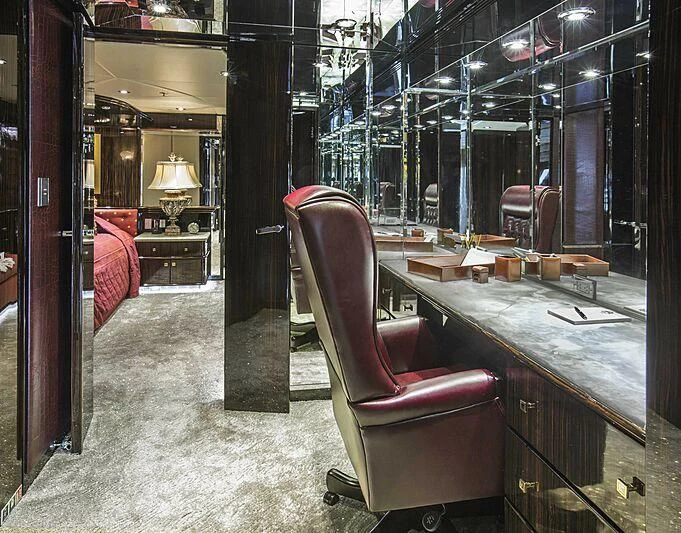 a room with a desk and a chair aboard GRADE I Yacht for Charter
