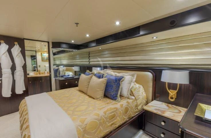 a bed with a white sheet and pillows aboard GRADE I Yacht for Charter