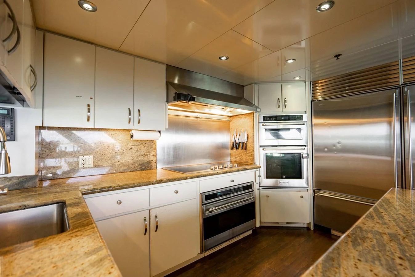 a kitchen with white cabinets aboard GRADE I Yacht for Charter