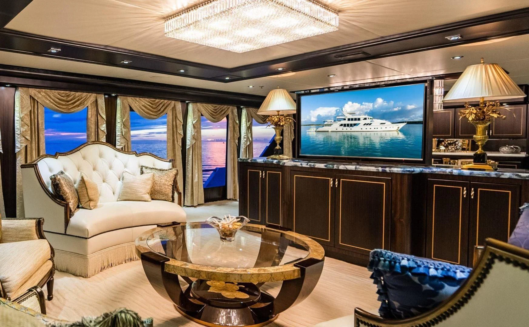 a living room with a large screen aboard GRADE I Yacht for Charter