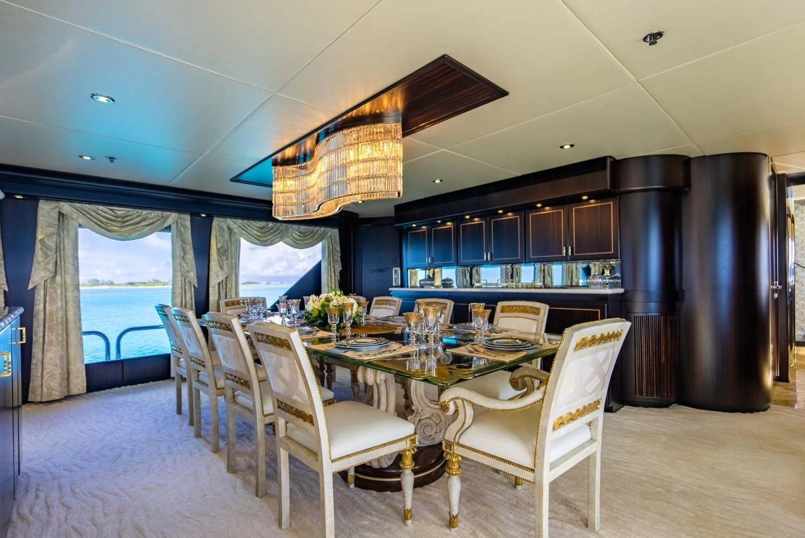 a dining room with a chandelier aboard GRADE I Yacht for Charter