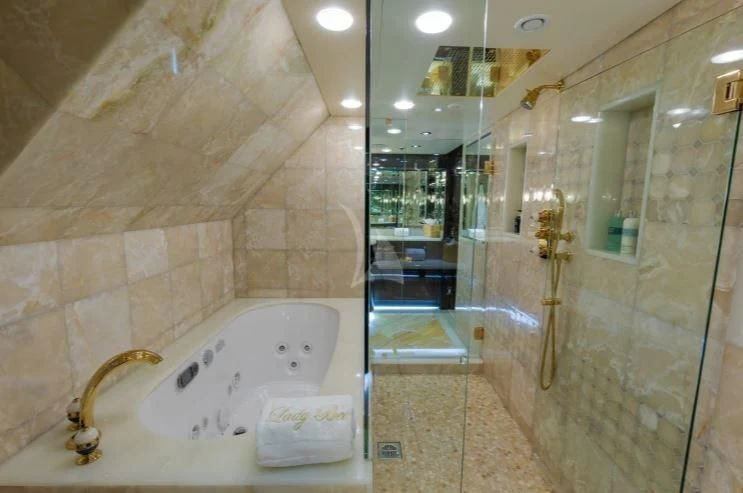 a bathroom with a glass shower aboard GRADE I Yacht for Charter