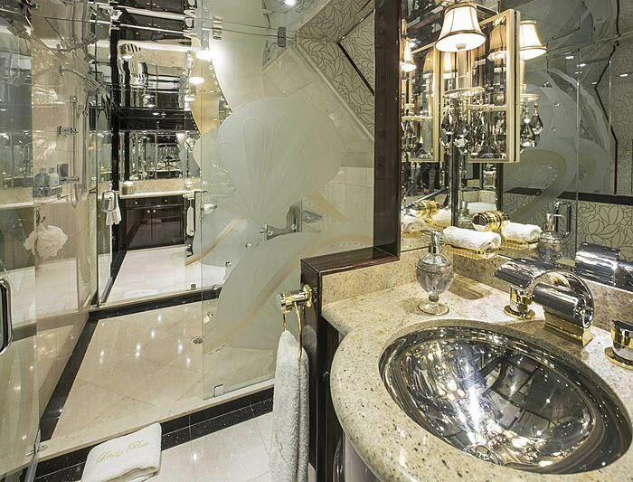 a bathroom with a sink and a large mirror aboard GRADE I Yacht for Charter
