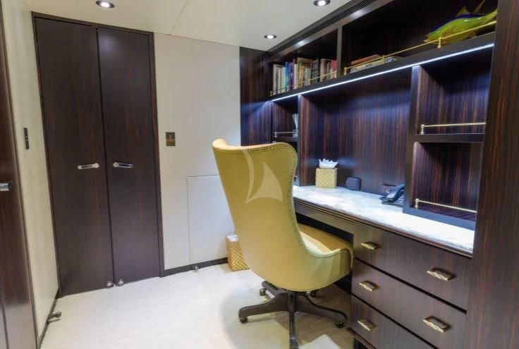 a yellow chair in a room aboard GRADE I Yacht for Charter