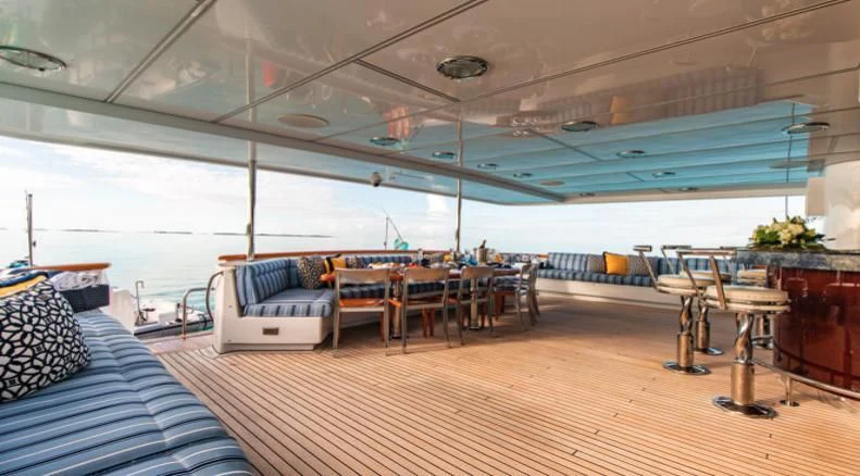 a room with a couch and a table and chairs aboard GRADE I Yacht for Charter