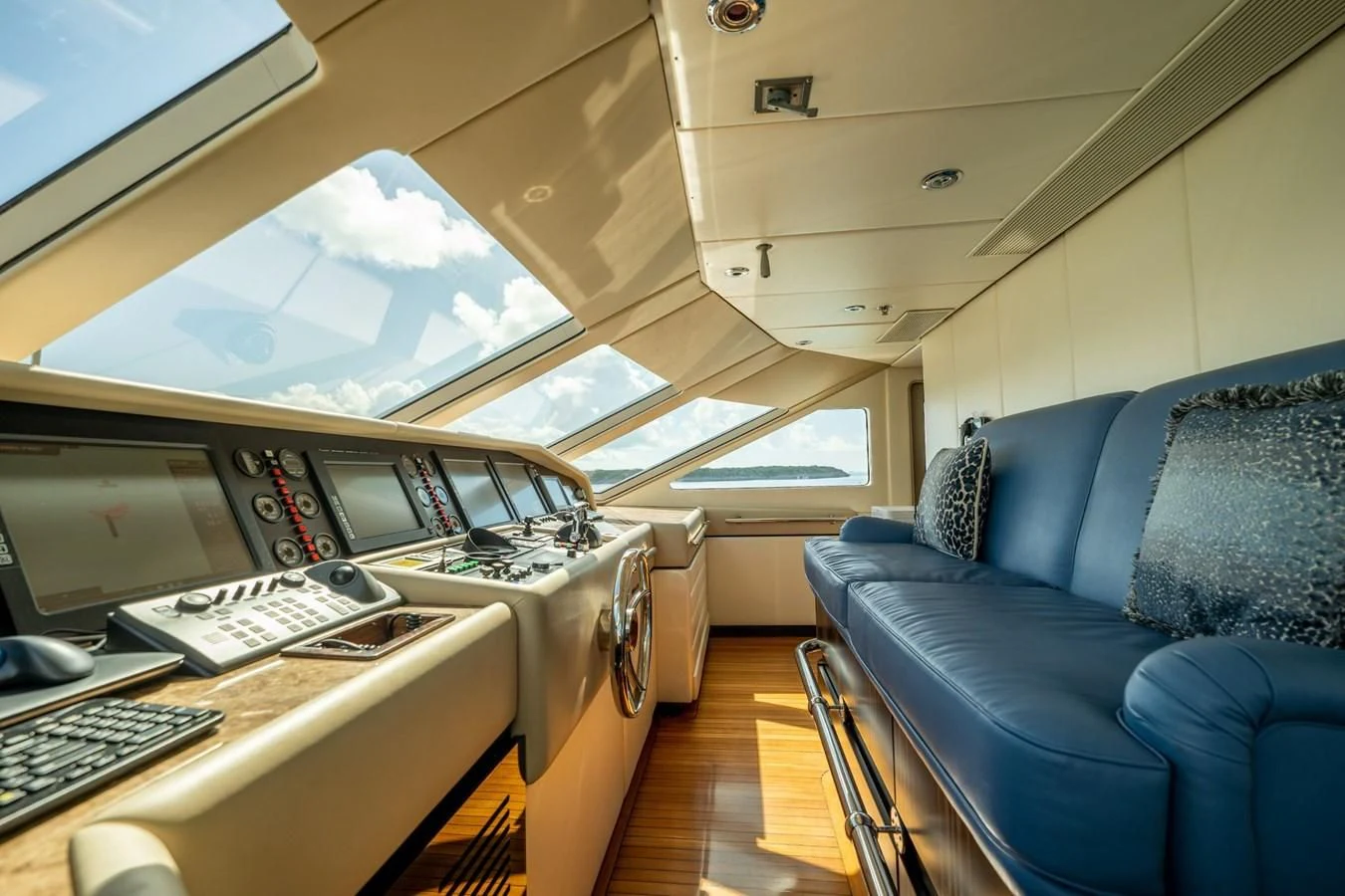 a room with a couch and computers aboard GRADE I Yacht for Charter