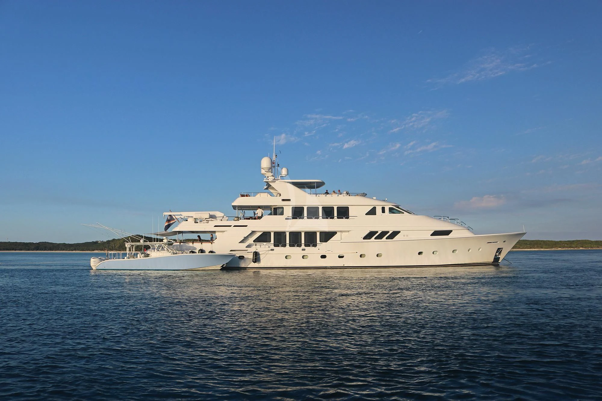 a large white yacht in the water aboard GRADE I Yacht for Charter