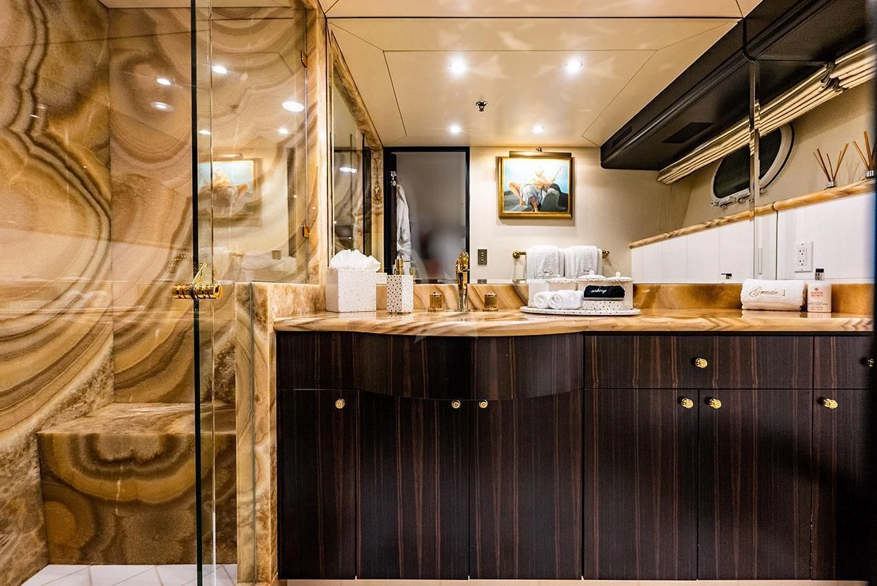 a bathroom with a large mirror aboard GRADE I Yacht for Charter