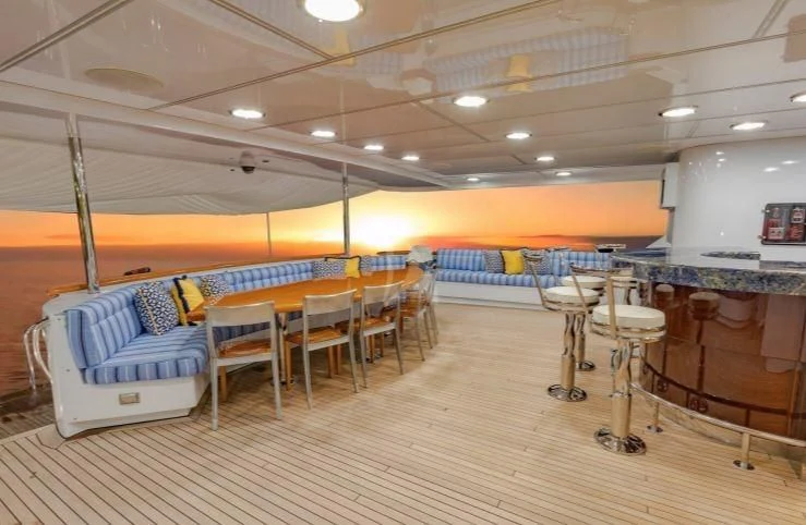 a room with chairs and tables aboard GRADE I Yacht for Charter