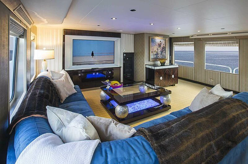 a living room with a couch and a coffee table aboard GRADE I Yacht for Charter