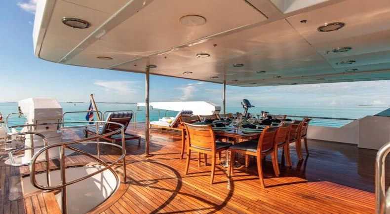 a room with a table and chairs aboard GRADE I Yacht for Charter