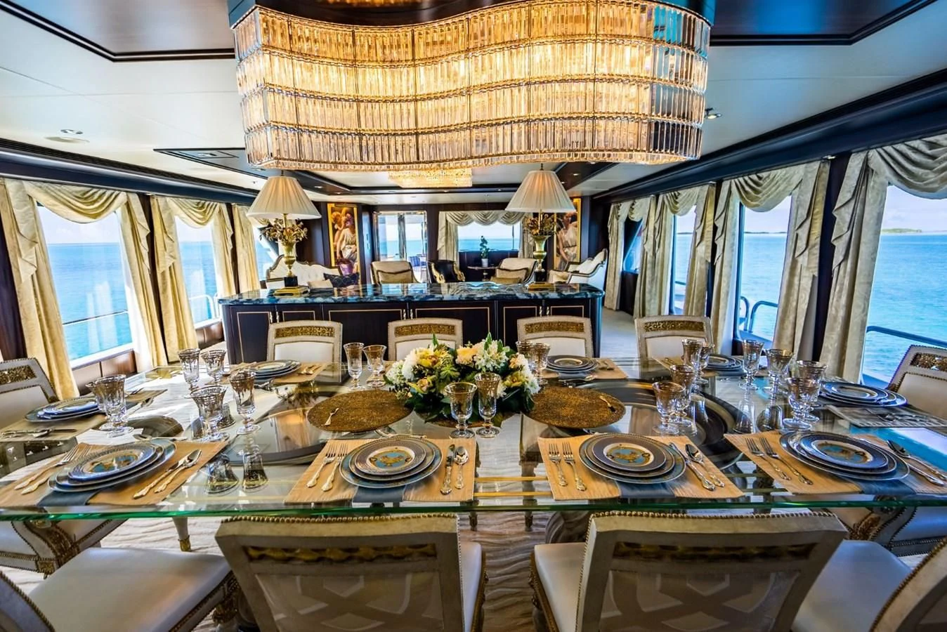 a large dining room with a large table set for a formal dinner aboard GRADE I Yacht for Charter