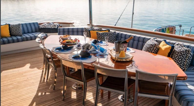 a table set for a meal on a boat aboard GRADE I Yacht for Charter