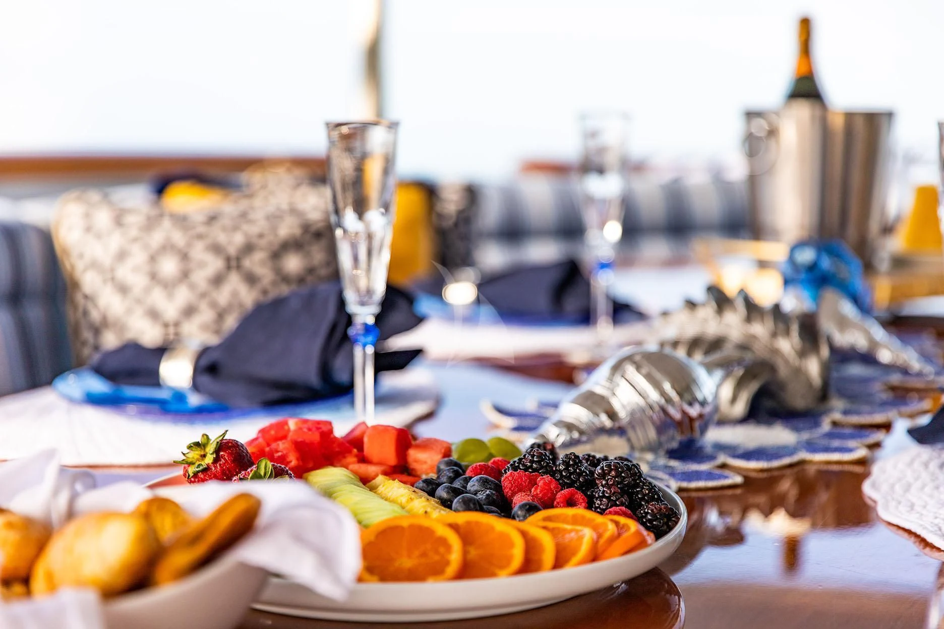 a plate of fruit and wine aboard GRADE I Yacht for Charter