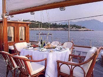 a table set for a meal on a boat aboard LIANA H Yacht for Charter