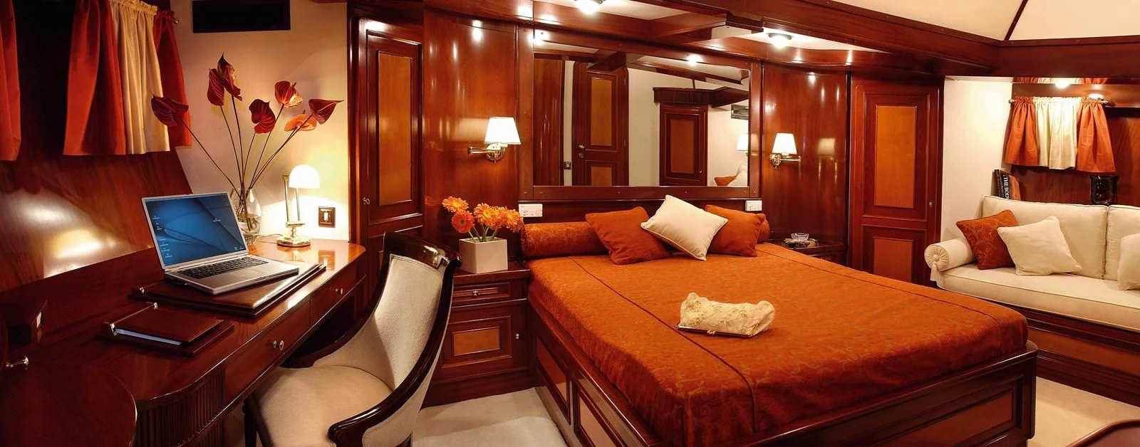 a bedroom with a bed and a desk aboard LIANA H Yacht for Charter