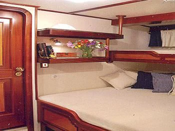 a bed with a flowered bed aboard LIANA H Yacht for Charter