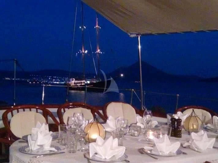 a table set with dinnerware aboard LIANA H Yacht for Charter