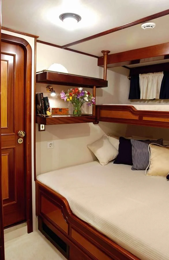 a bed with a mirror above it aboard LIANA H Yacht for Charter