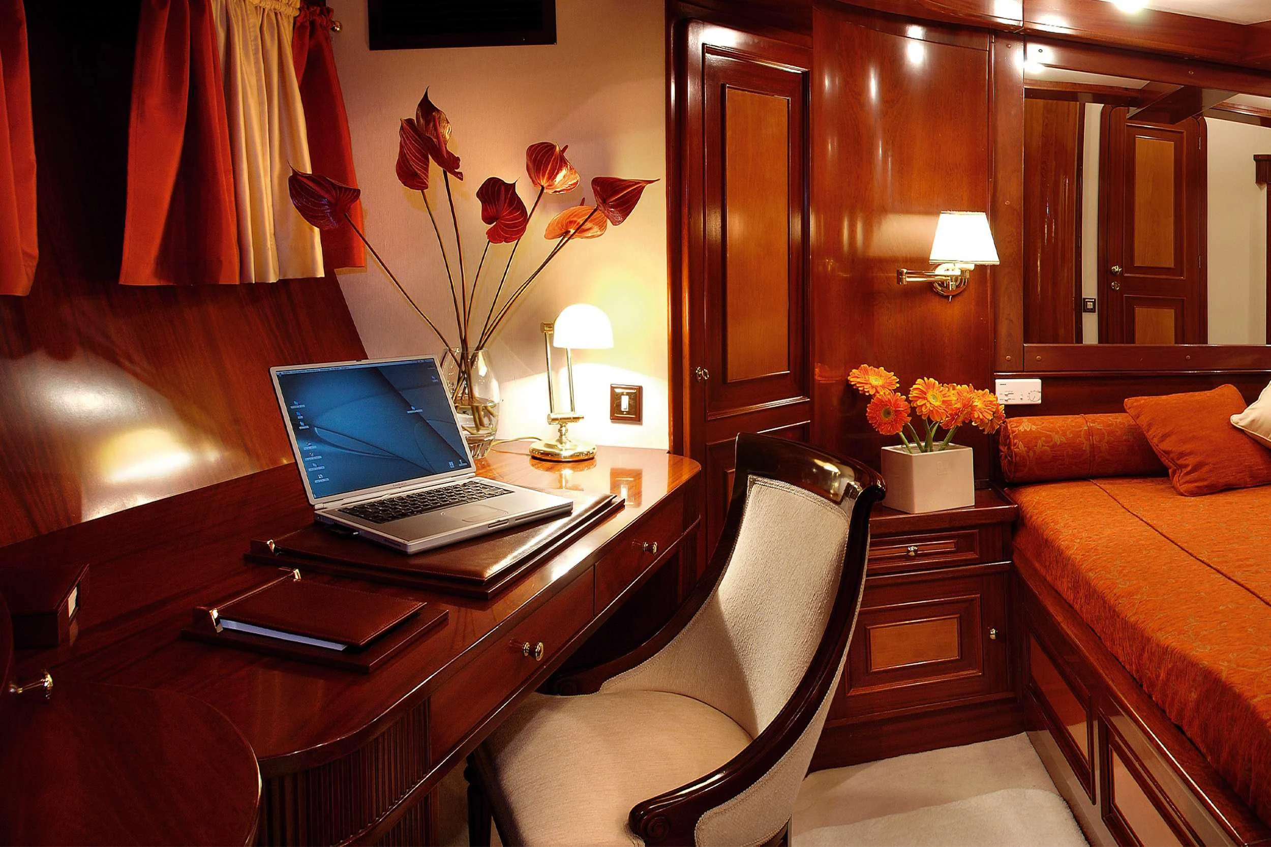 a laptop on a desk aboard LIANA H Yacht for Charter