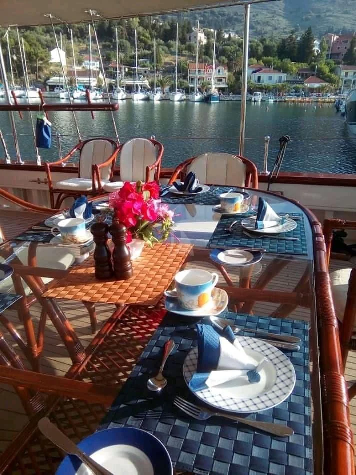 a table with plates and cups on it aboard LIANA H Yacht for Charter