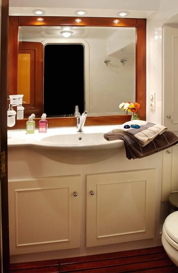 a bathroom with a large mirror aboard LIANA H Yacht for Charter
