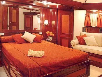 a bed with a large bed aboard LIANA H Yacht for Charter