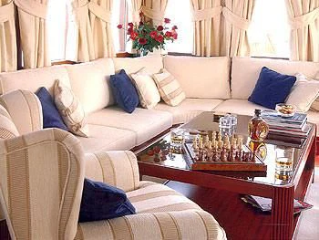 a living room with a couch and a coffee table aboard LIANA H Yacht for Charter