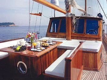 a boat with a table and chairs aboard LIANA H Yacht for Charter