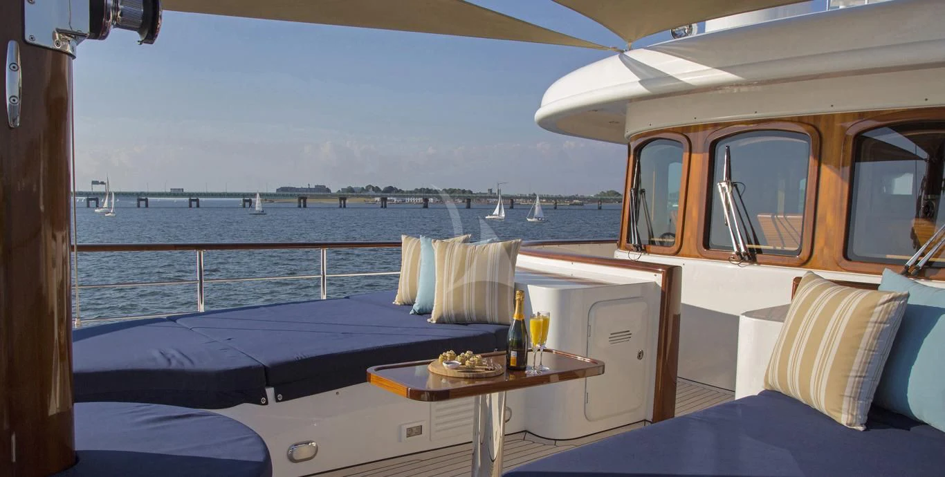 a room with a table and a bed aboard OMNIA 1 Yacht for Sale