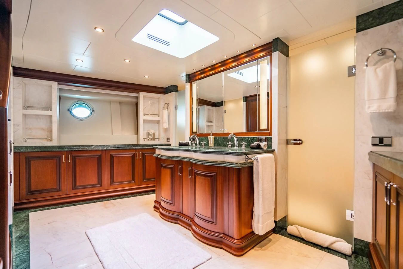 a bathroom with wooden cabinets aboard OMNIA 1 Yacht for Sale