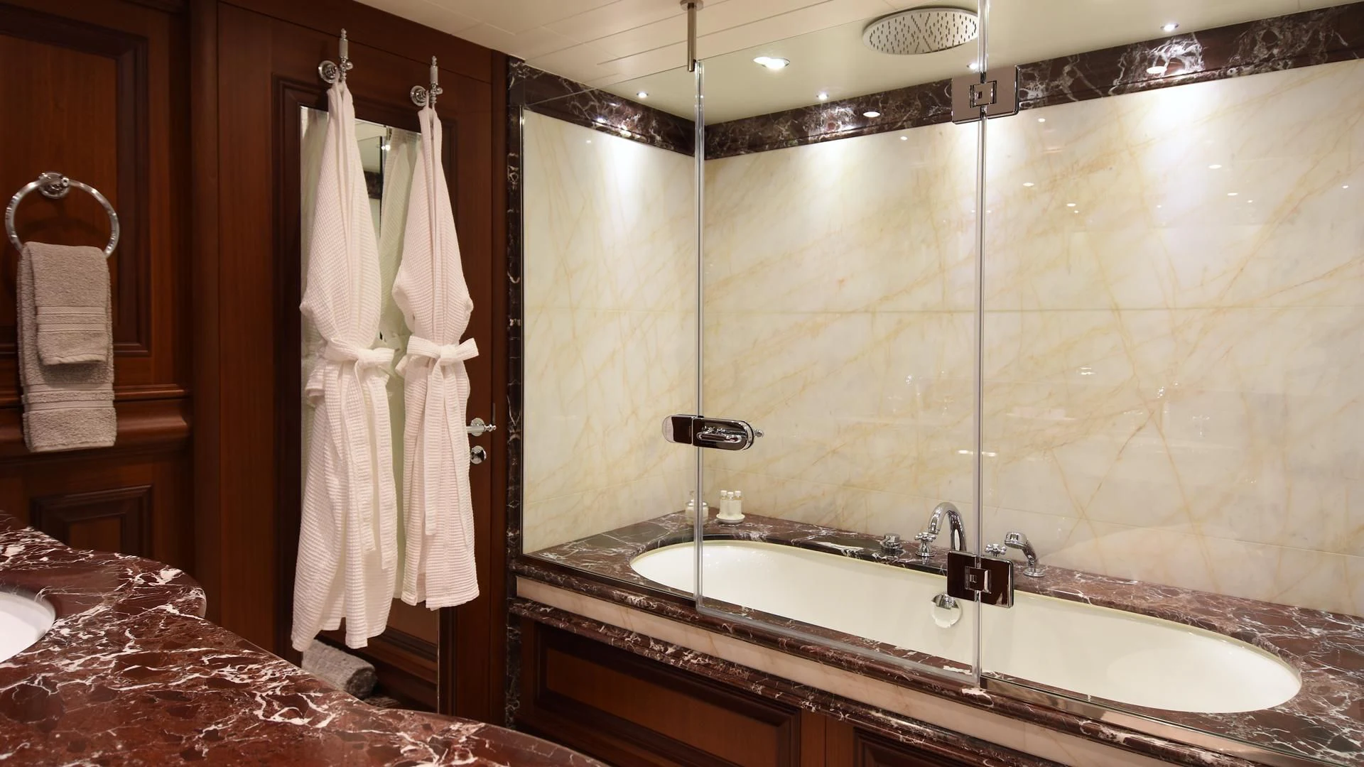 a bathroom with a large mirror aboard OMNIA 1 Yacht for Sale