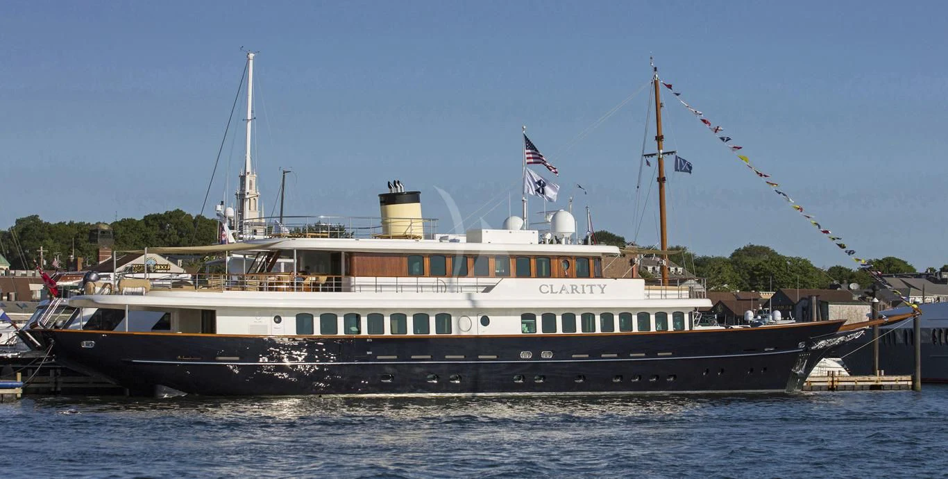 a large boat with a flag on it aboard OMNIA 1 Yacht for Sale