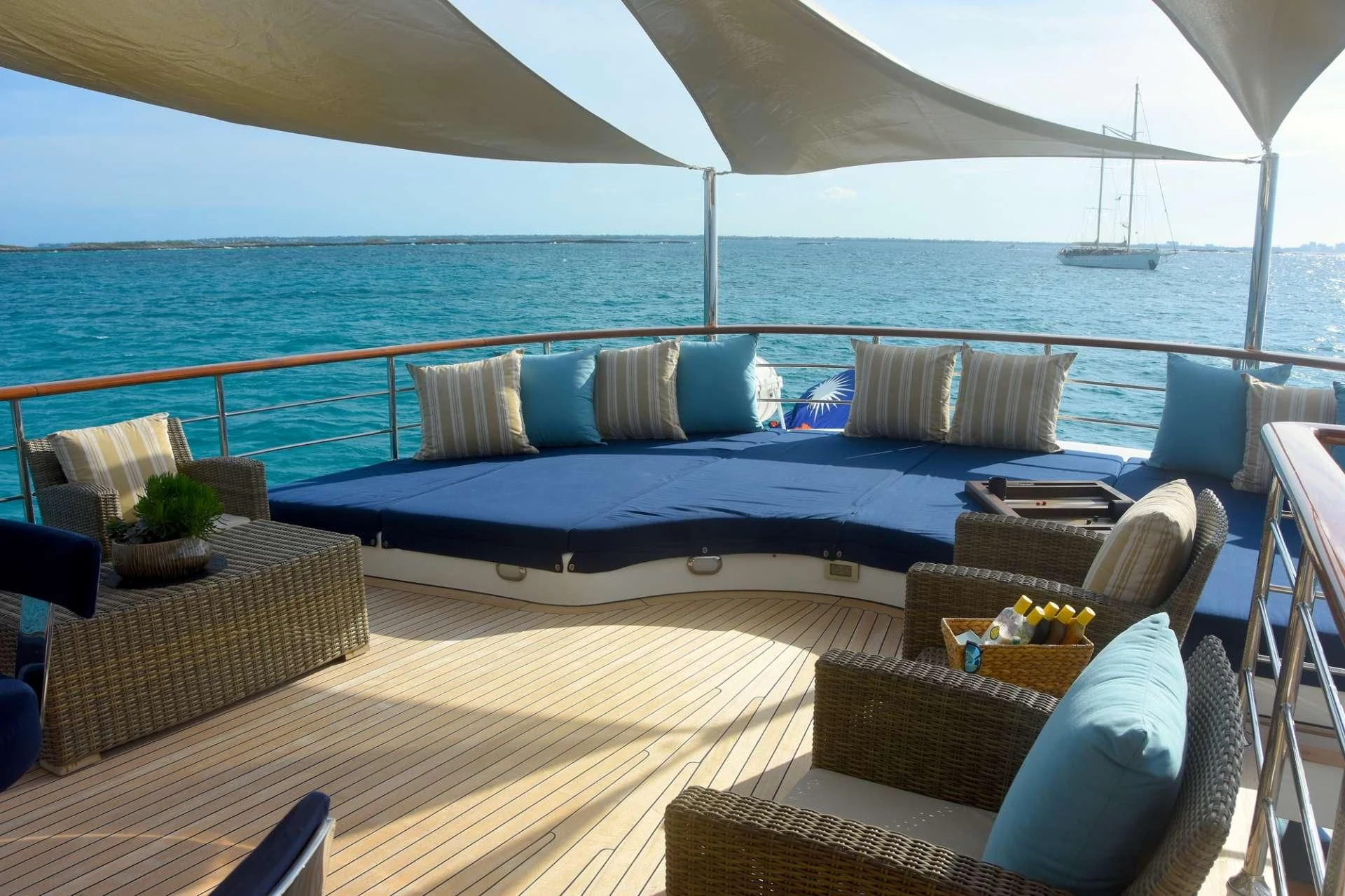 a large bed with a blue bed aboard OMNIA 1 Yacht for Sale