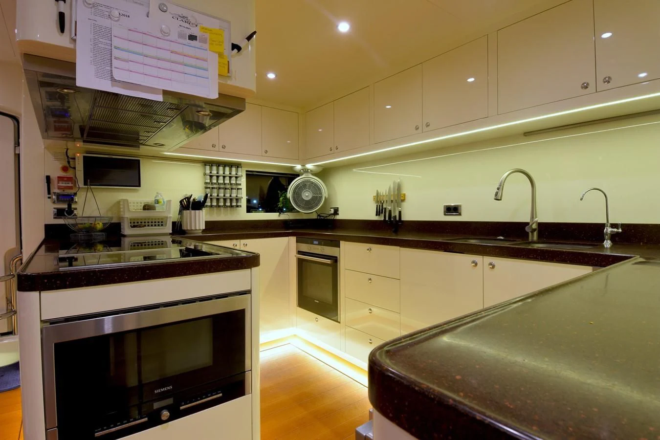 a kitchen with a stove and oven aboard OMNIA 1 Yacht for Sale