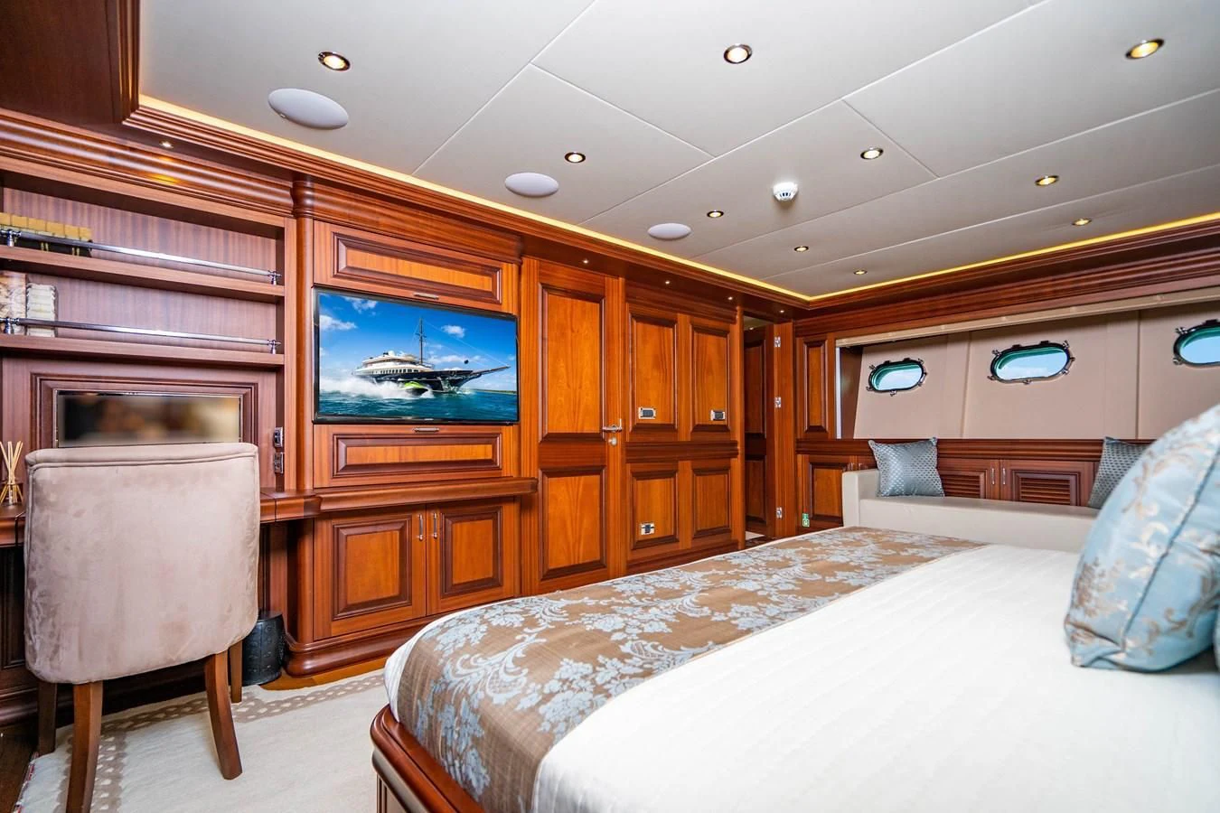 a bedroom with a bed and a television aboard OMNIA 1 Yacht for Sale