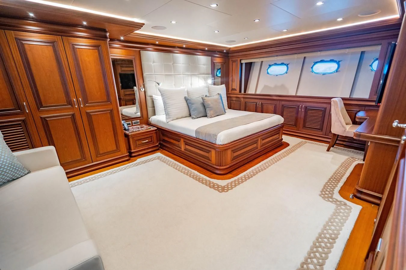 a room with a bed and a chair aboard OMNIA 1 Yacht for Sale