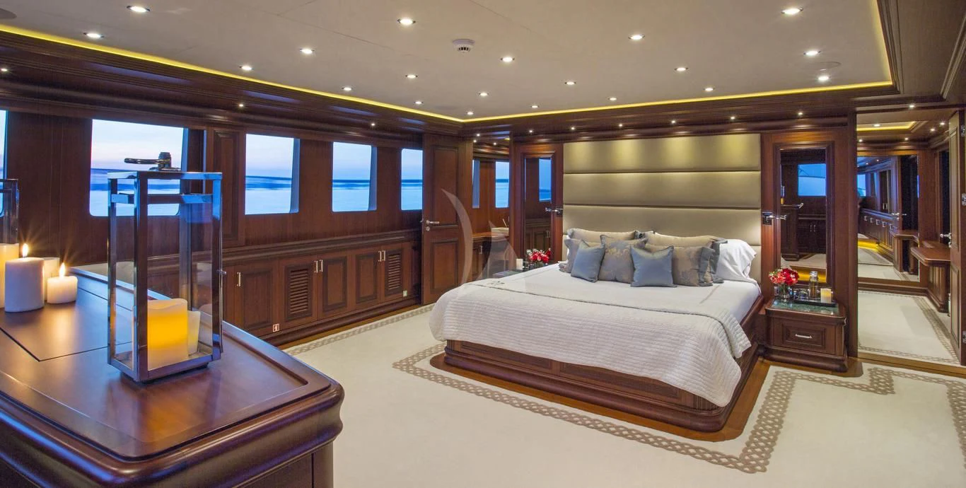 a hotel room with a bed and a table aboard OMNIA 1 Yacht for Sale