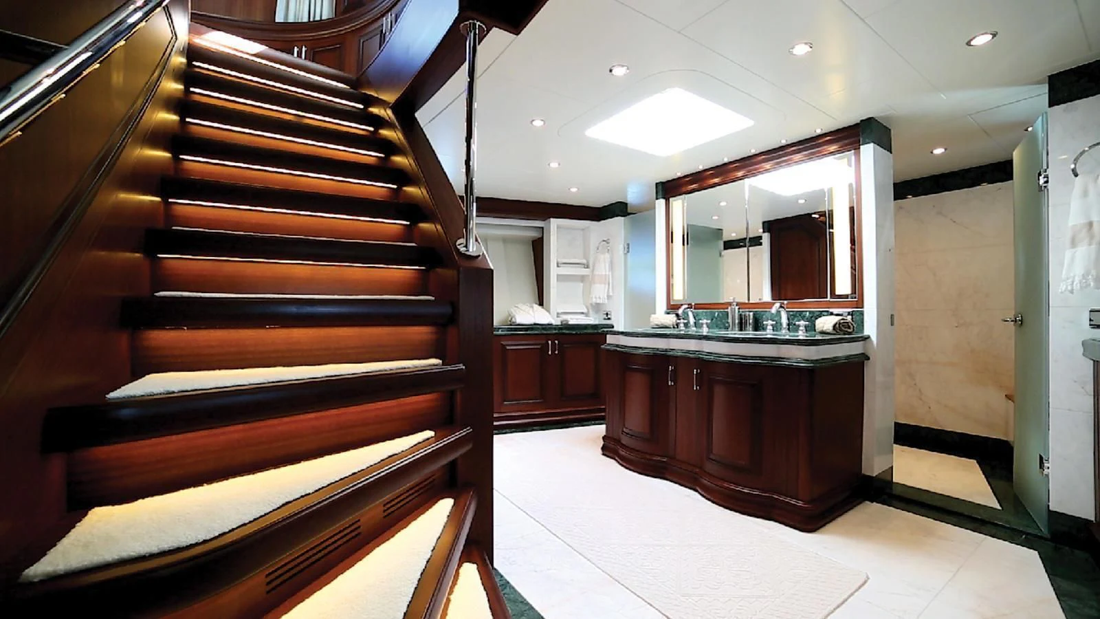 a large kitchen with wooden stairs aboard OMNIA 1 Yacht for Sale