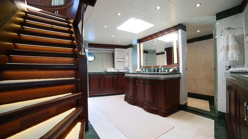 a kitchen with wooden cabinets aboard OMNIA 1 Yacht for Sale