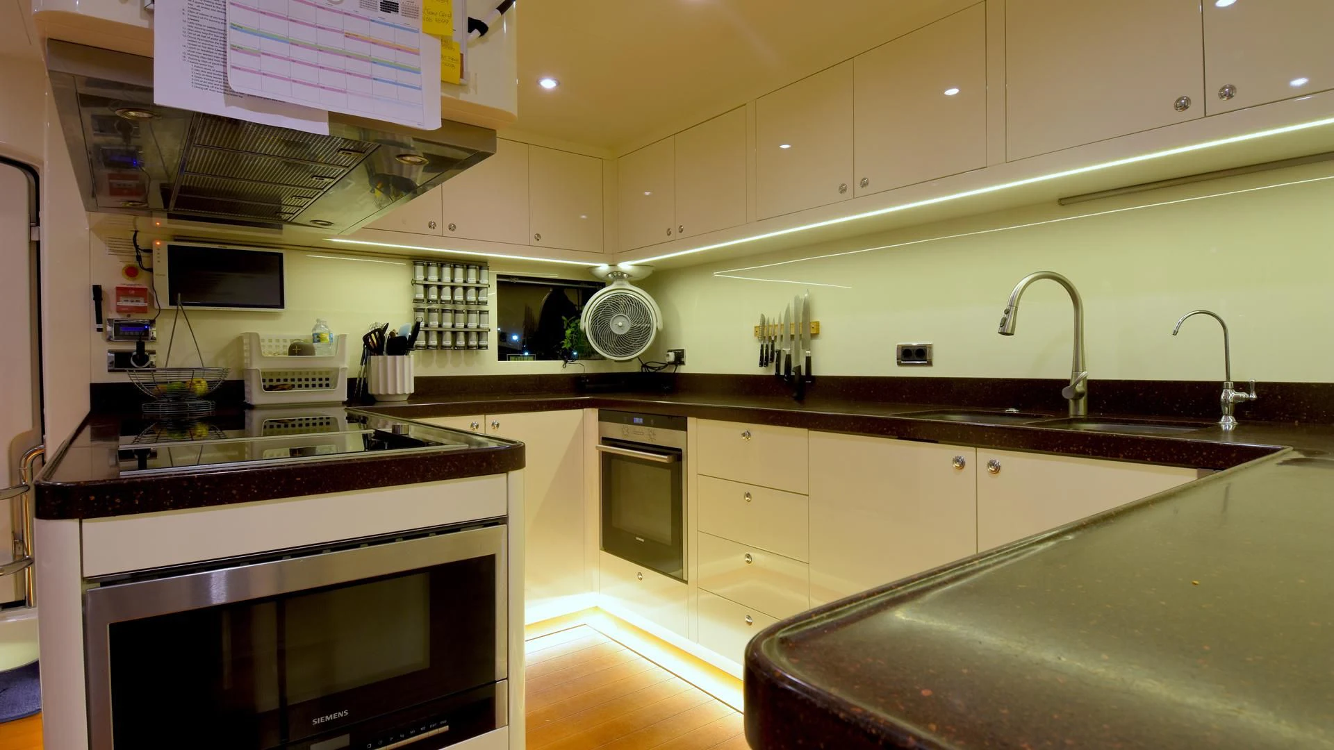 a kitchen with white cabinets aboard OMNIA 1 Yacht for Sale