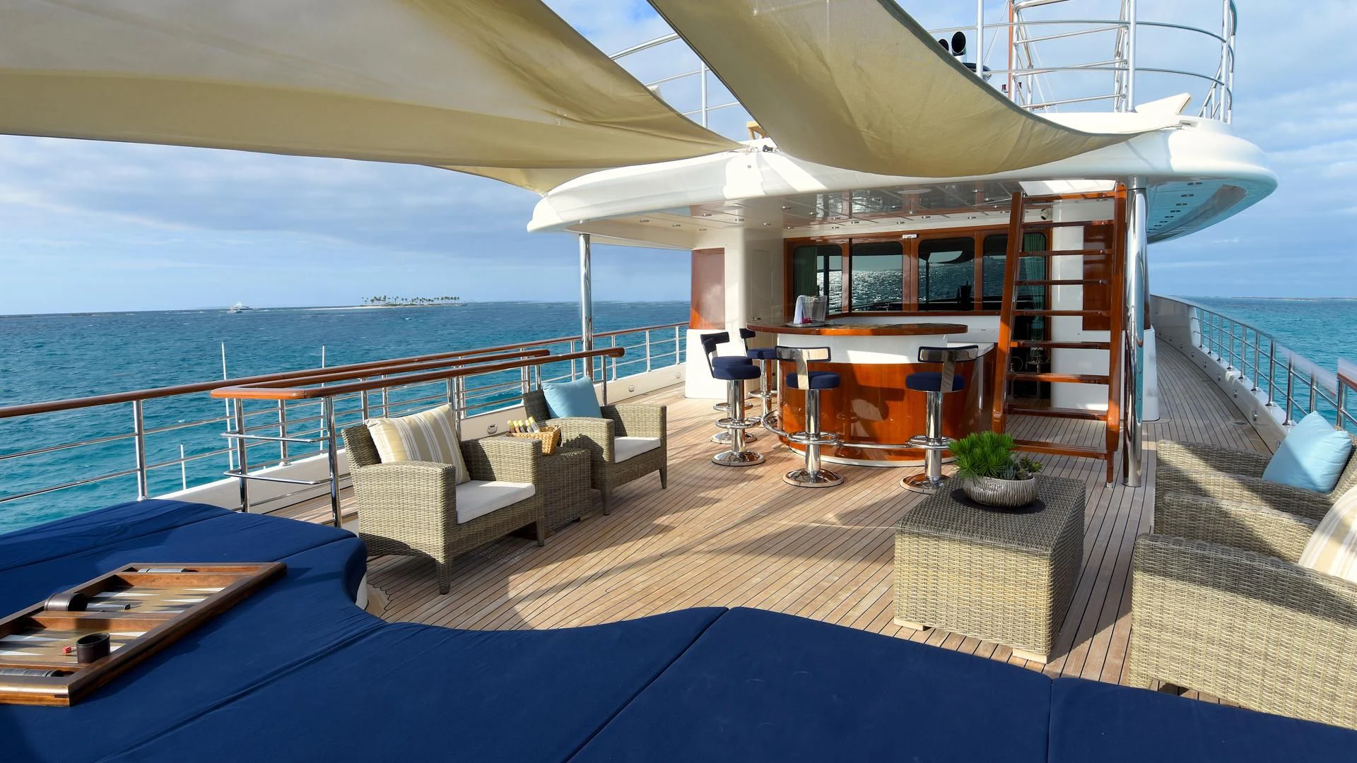 a deck with a pool and a lounge chair and a large body of water aboard OMNIA 1 Yacht for Sale