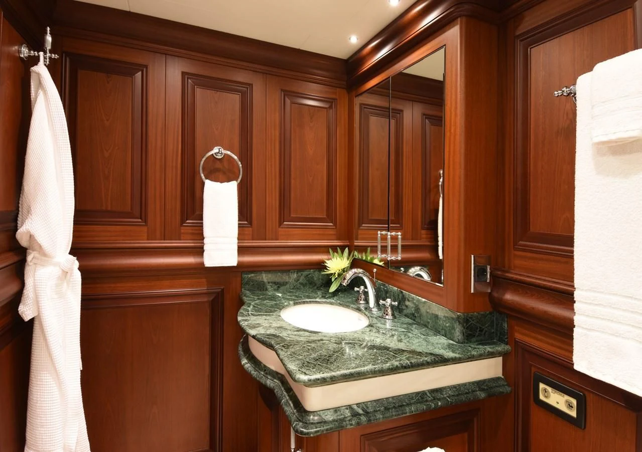 a bathroom with a sink and a towel on the wall aboard OMNIA 1 Yacht for Sale