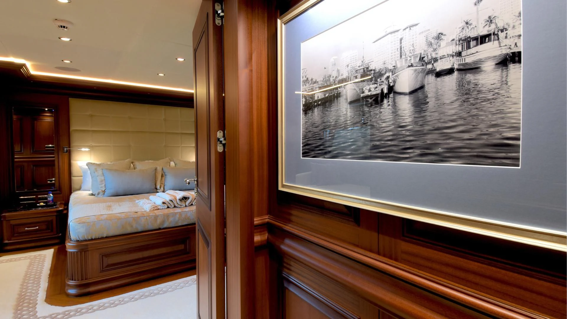 a bedroom with a large mirror aboard OMNIA 1 Yacht for Sale
