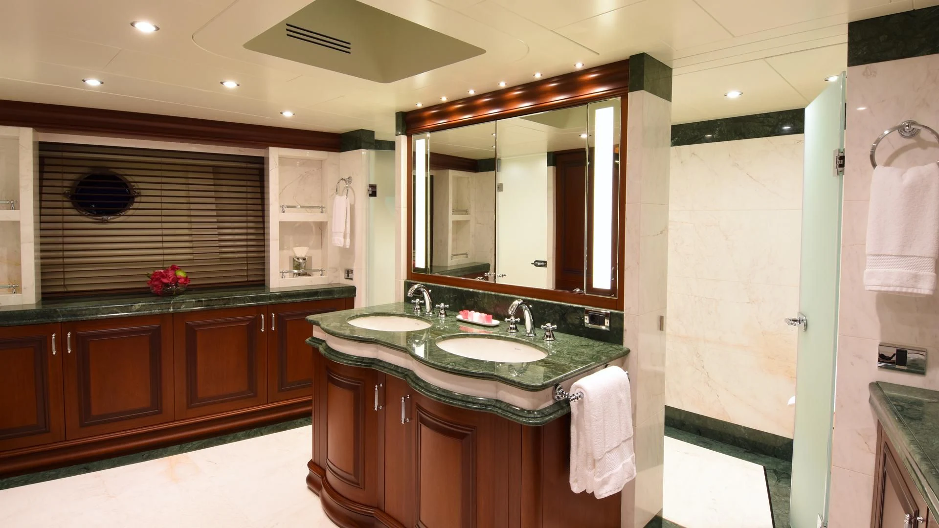 a bathroom with a large mirror aboard OMNIA 1 Yacht for Sale