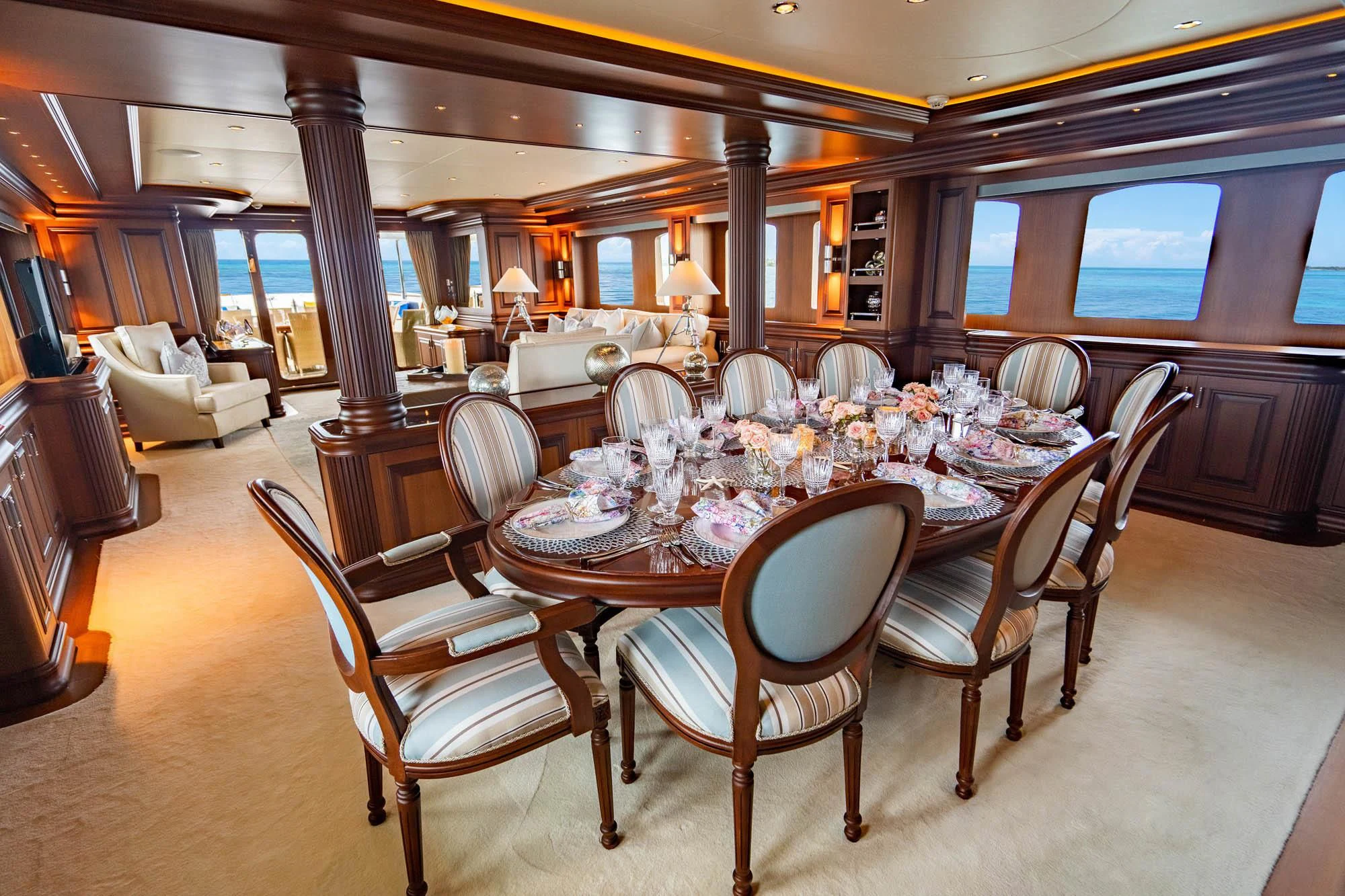 a large dining table in a large room aboard OMNIA 1 Yacht for Sale