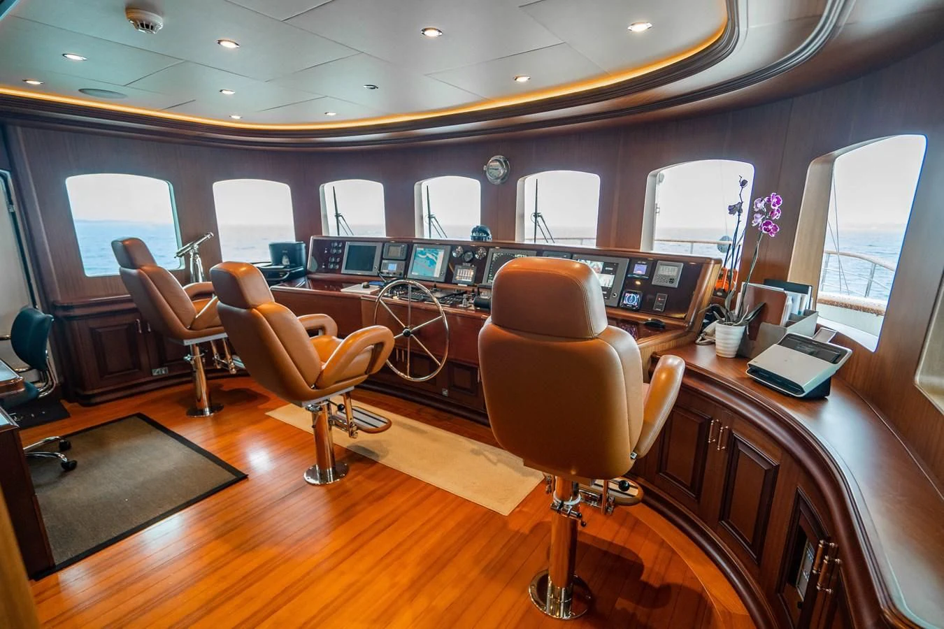 a room with a table chairs and a large window aboard OMNIA 1 Yacht for Sale